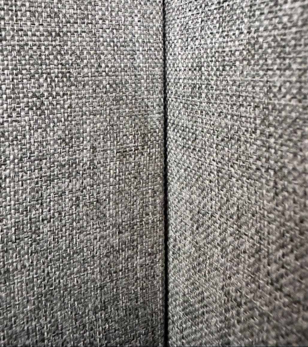 Grey textile wall installation with a clean inside corner seam