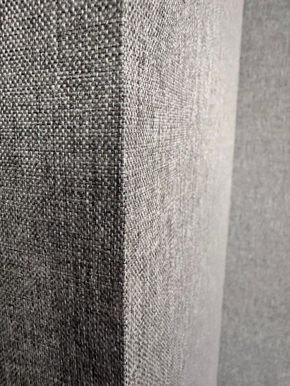 Grey textile wall installation with a wrapped outside corner detail