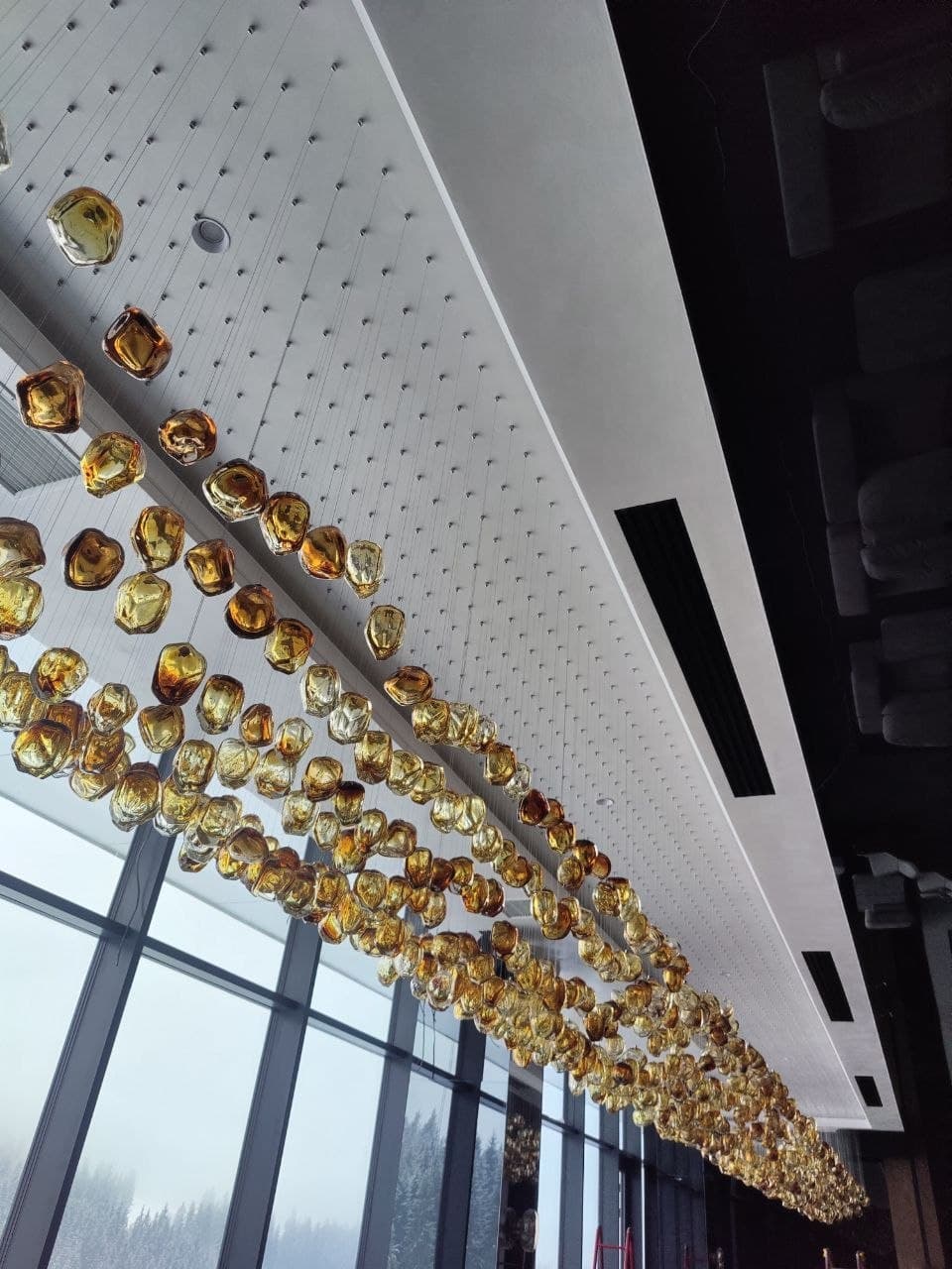 Decorative ceiling installation with suspended metallic spheres