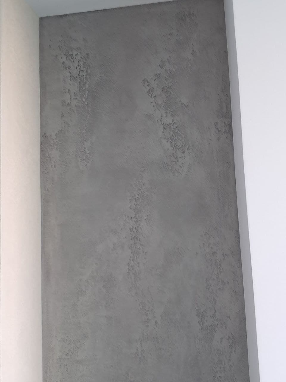 Microcement wall panel close-up with a raw mineral texture