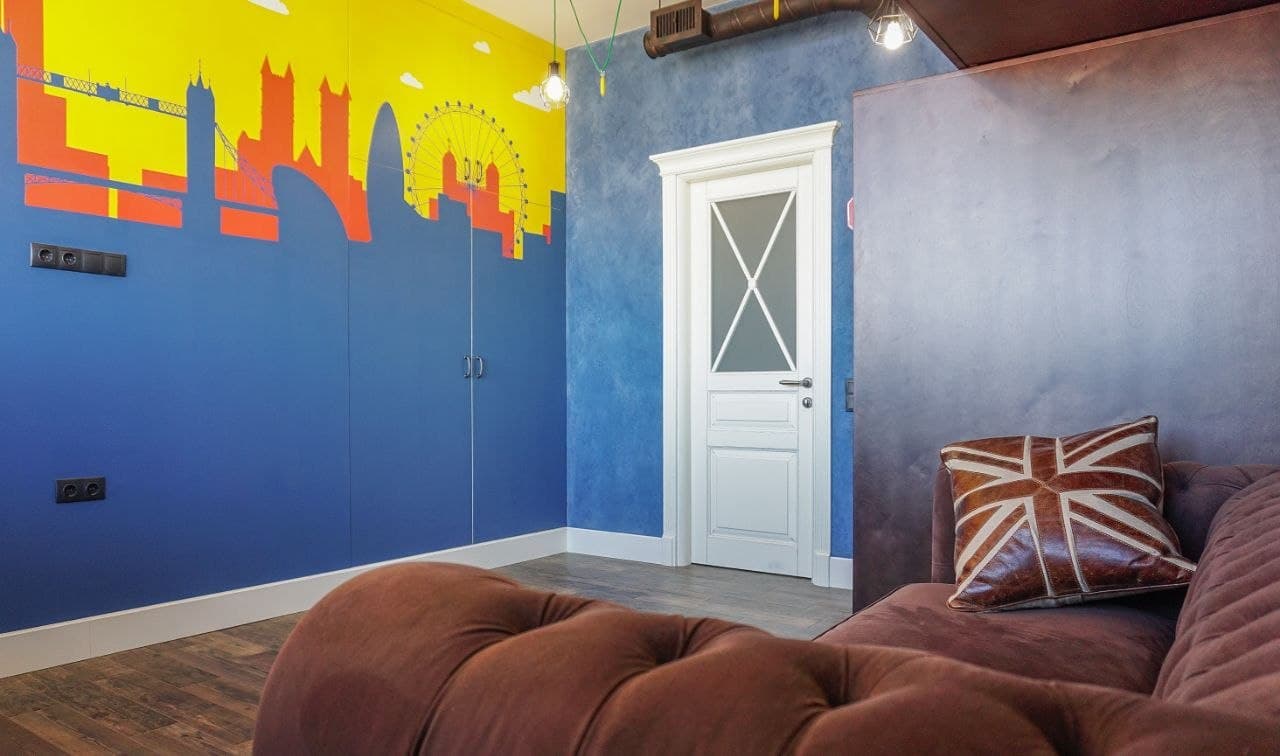 Accent wall with an artistic skyline painting and layered decorative color