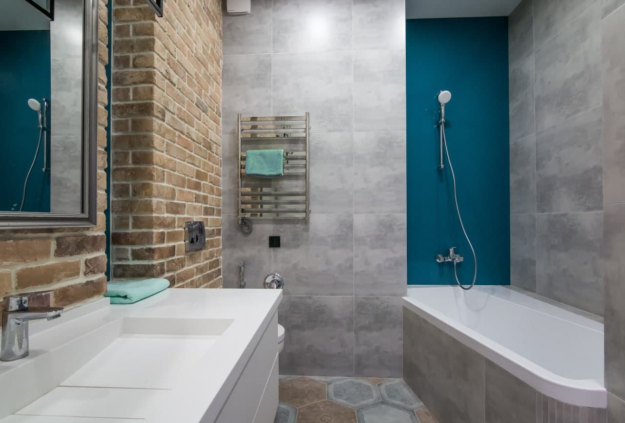 Bathroom with concrete-effect walls, a turquoise accent niche, and a suspended vanity