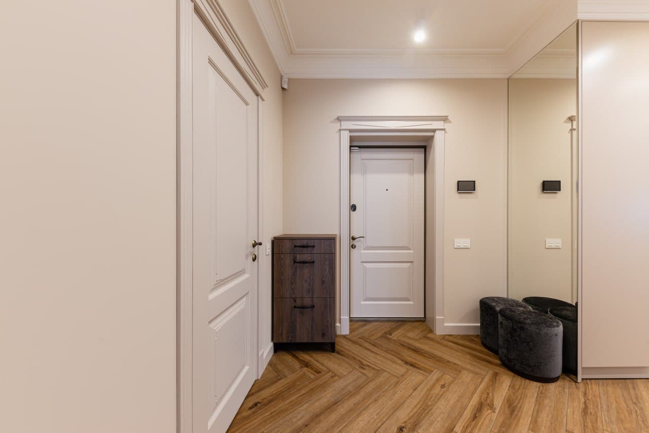 Corridor detail with paneled walls, decorative trim, and premium joinery
