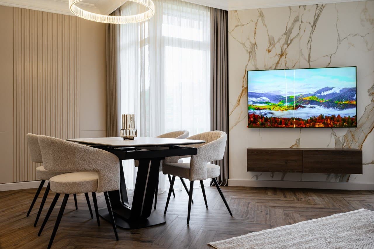 Dining area with a marble wall panel, fluted accent, and a custom media unit