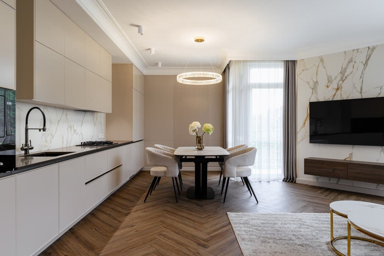 Open-plan kitchen and dining with a marble feature wall and clean architectural lines
