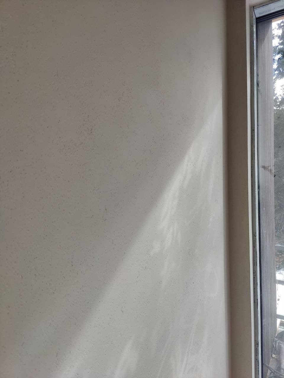Smooth lime plaster wall with a natural light gradient