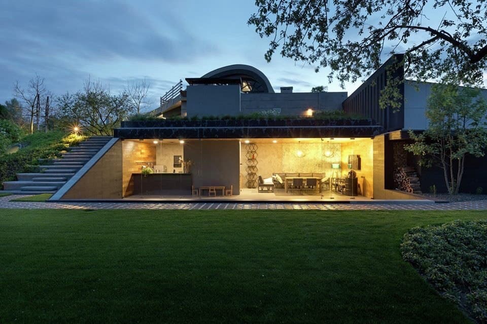 Night exterior with premium large-format villa tiles and an illuminated pool terrace