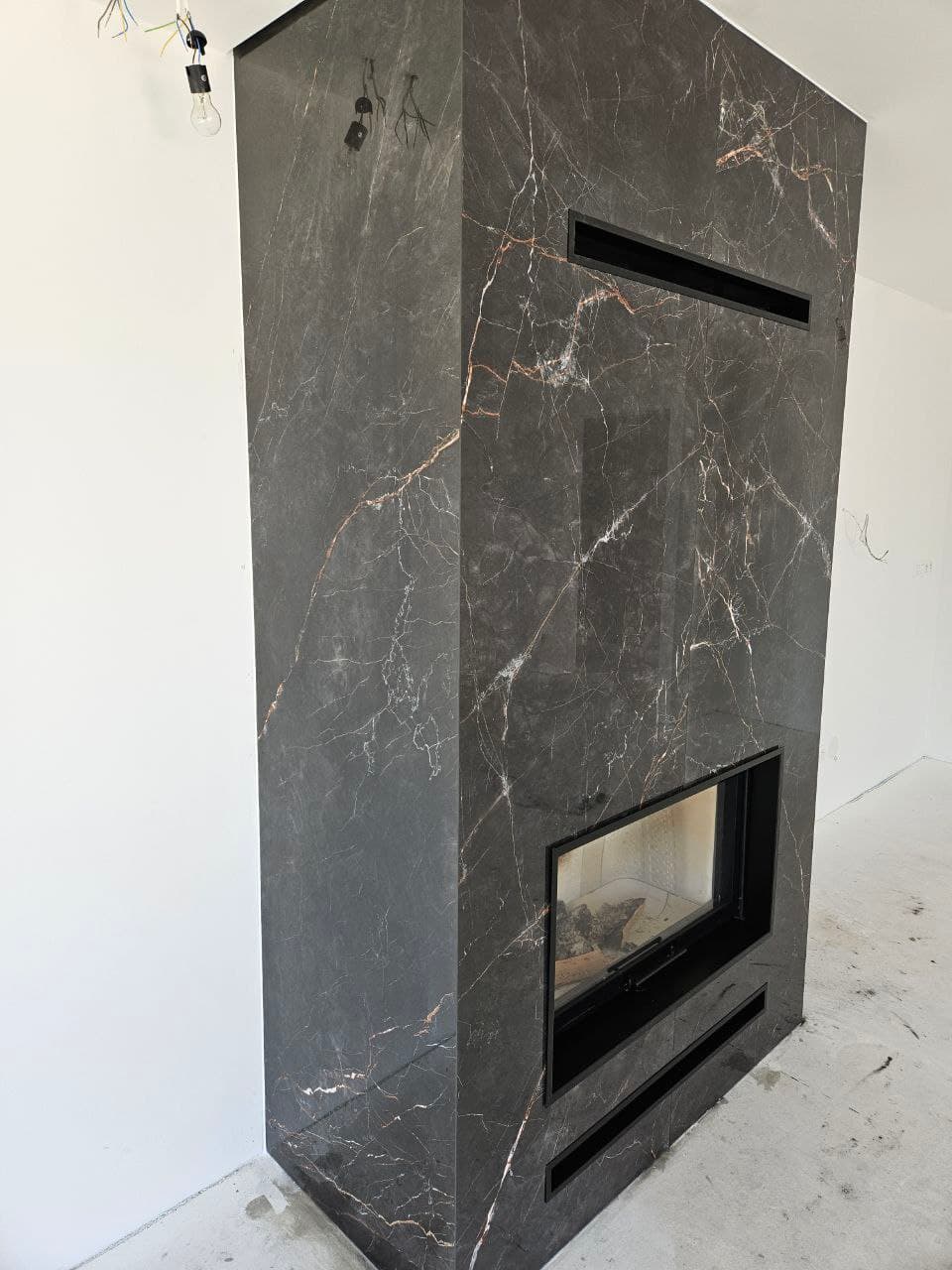 Stone-effect tile fireplace detail inside a contemporary living room