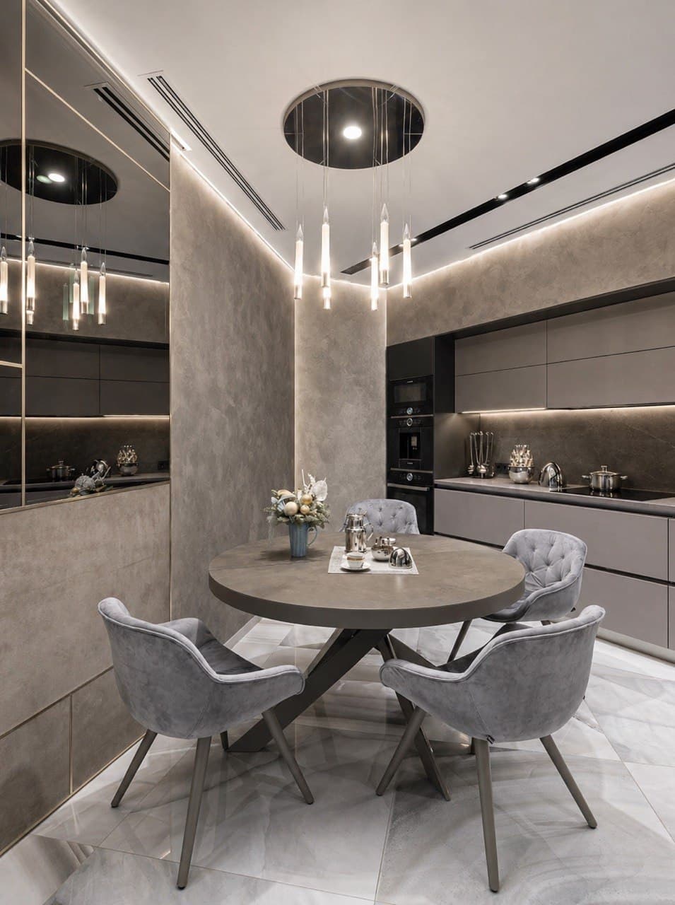 Dining nook with decorative wall finish, linear lighting, and a built-in kitchen
