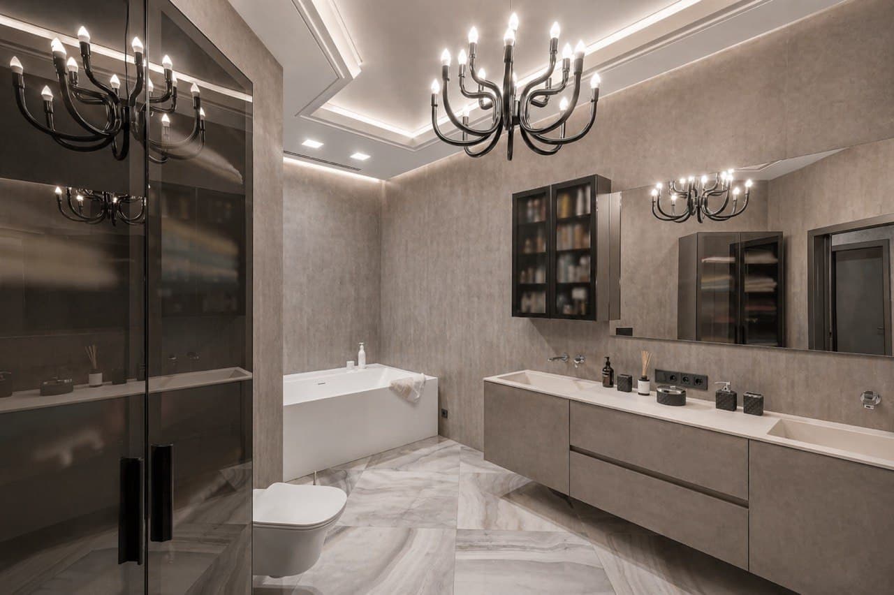 Luxury bathroom with decorative wall finish, a bathtub, and a double vanity