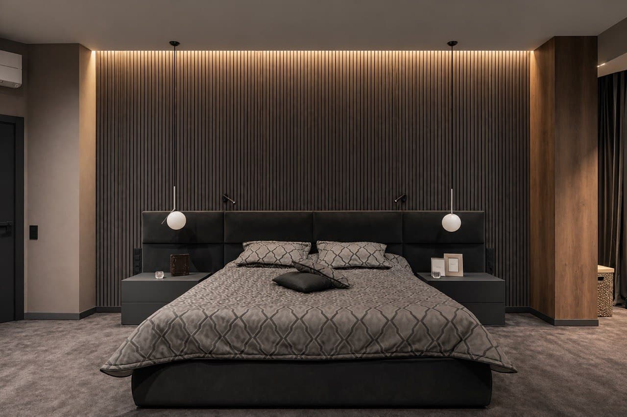 Master bedroom with ribbed wall panels, integrated lighting, and dark textiles