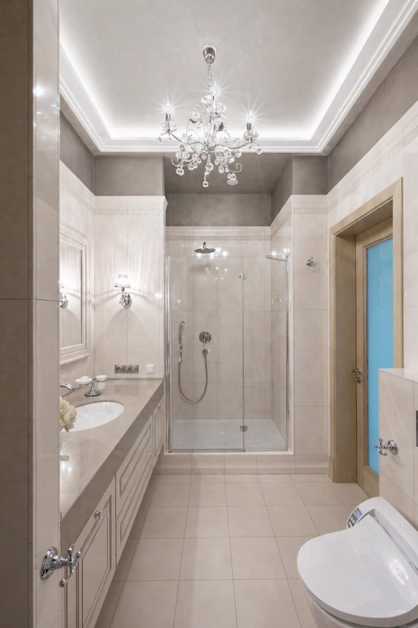 Bathroom with marble surfaces, a decorative ceiling, and a glass shower