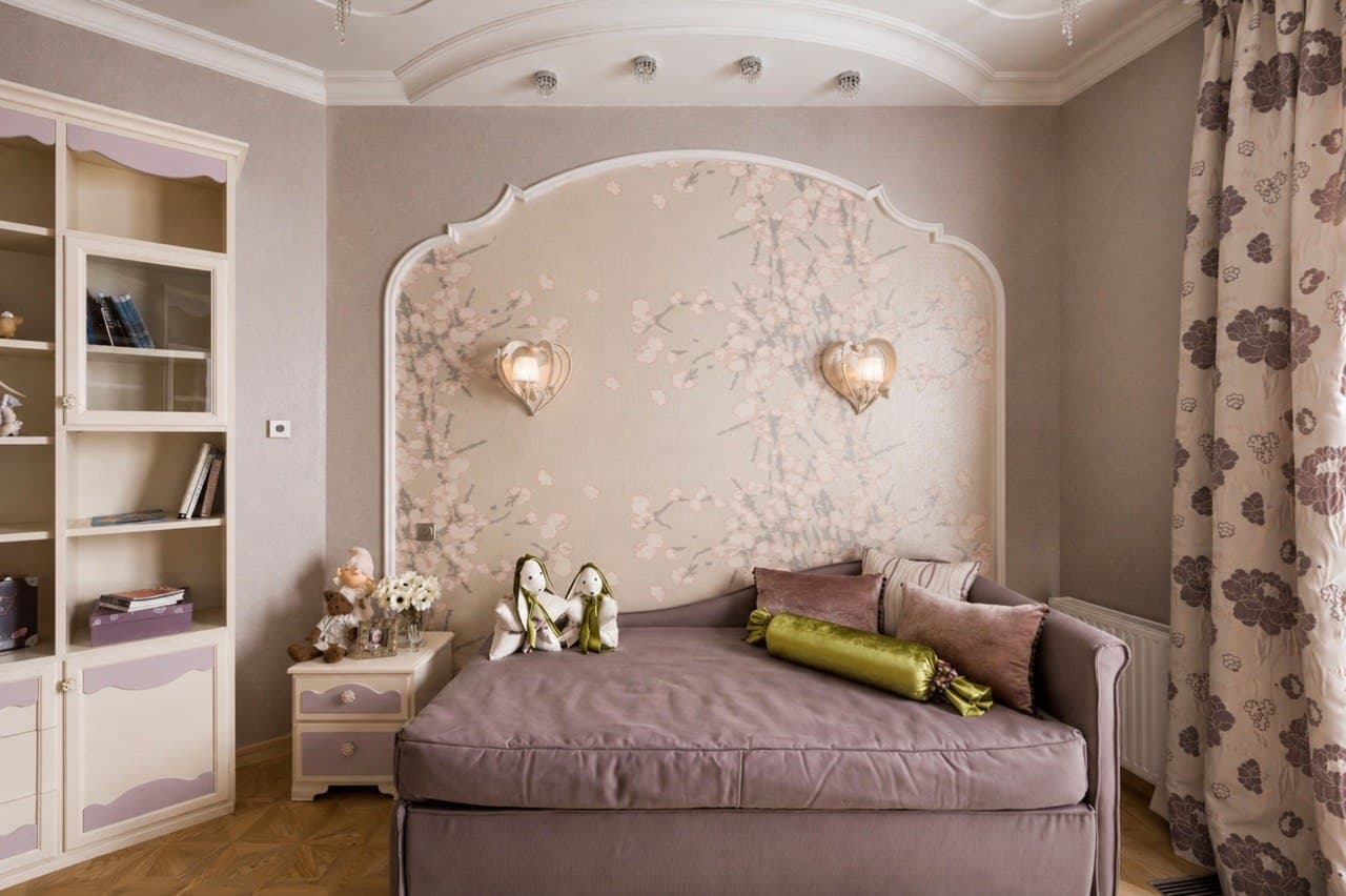 Bedroom with a sculpted headboard wall, decorative plaster relief, and custom shelving