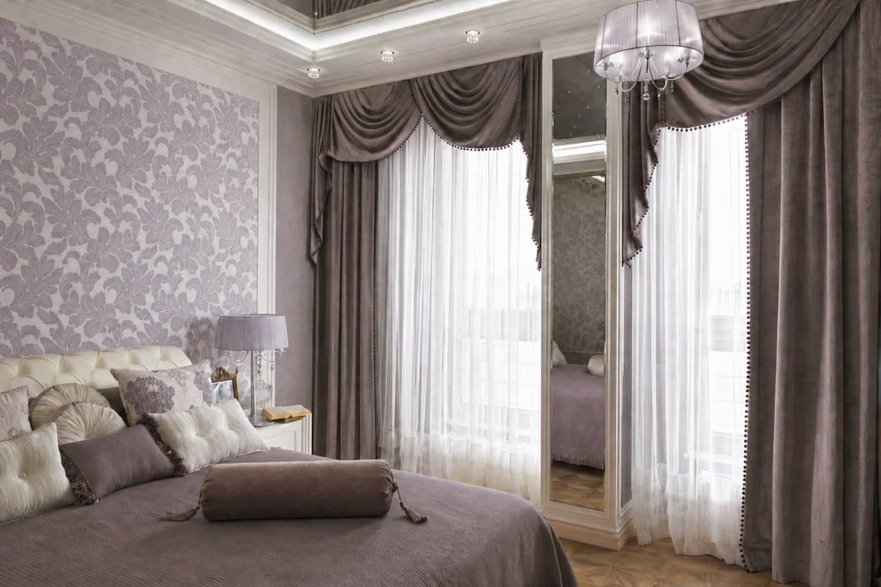 Bedroom seating corner with a floral wall finish and a crystal chandelier