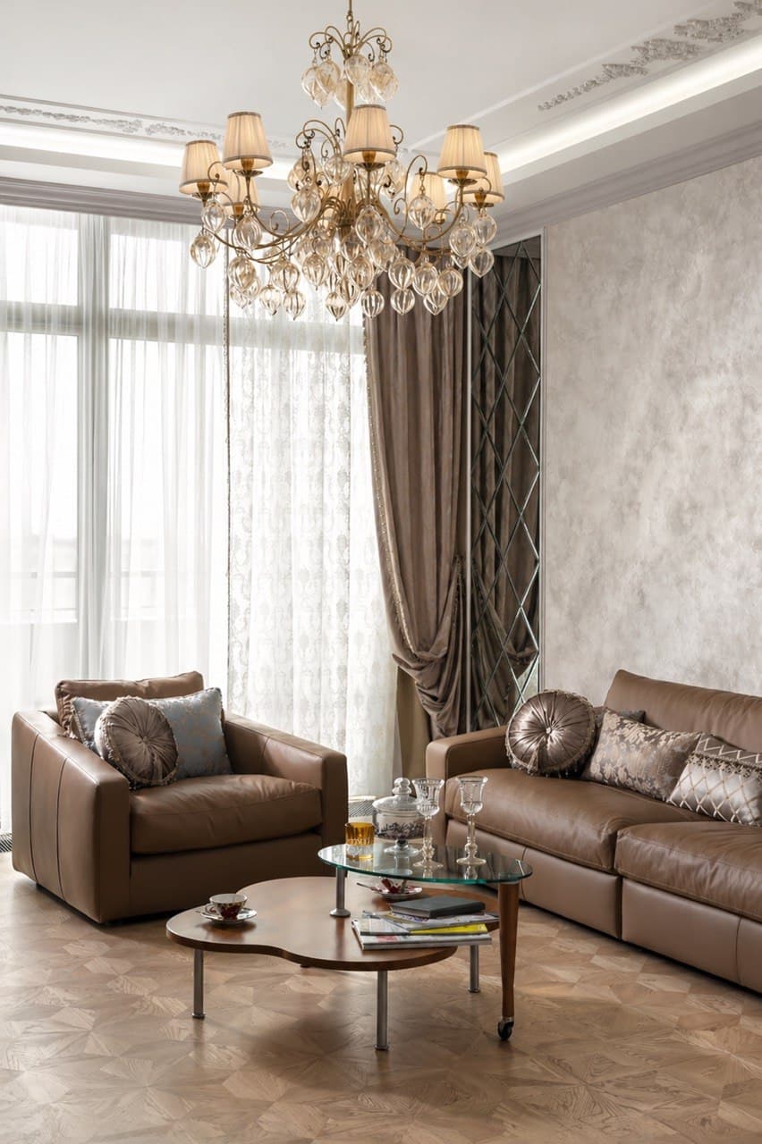 Living room with a decorative wall finish, chandelier, and French windows