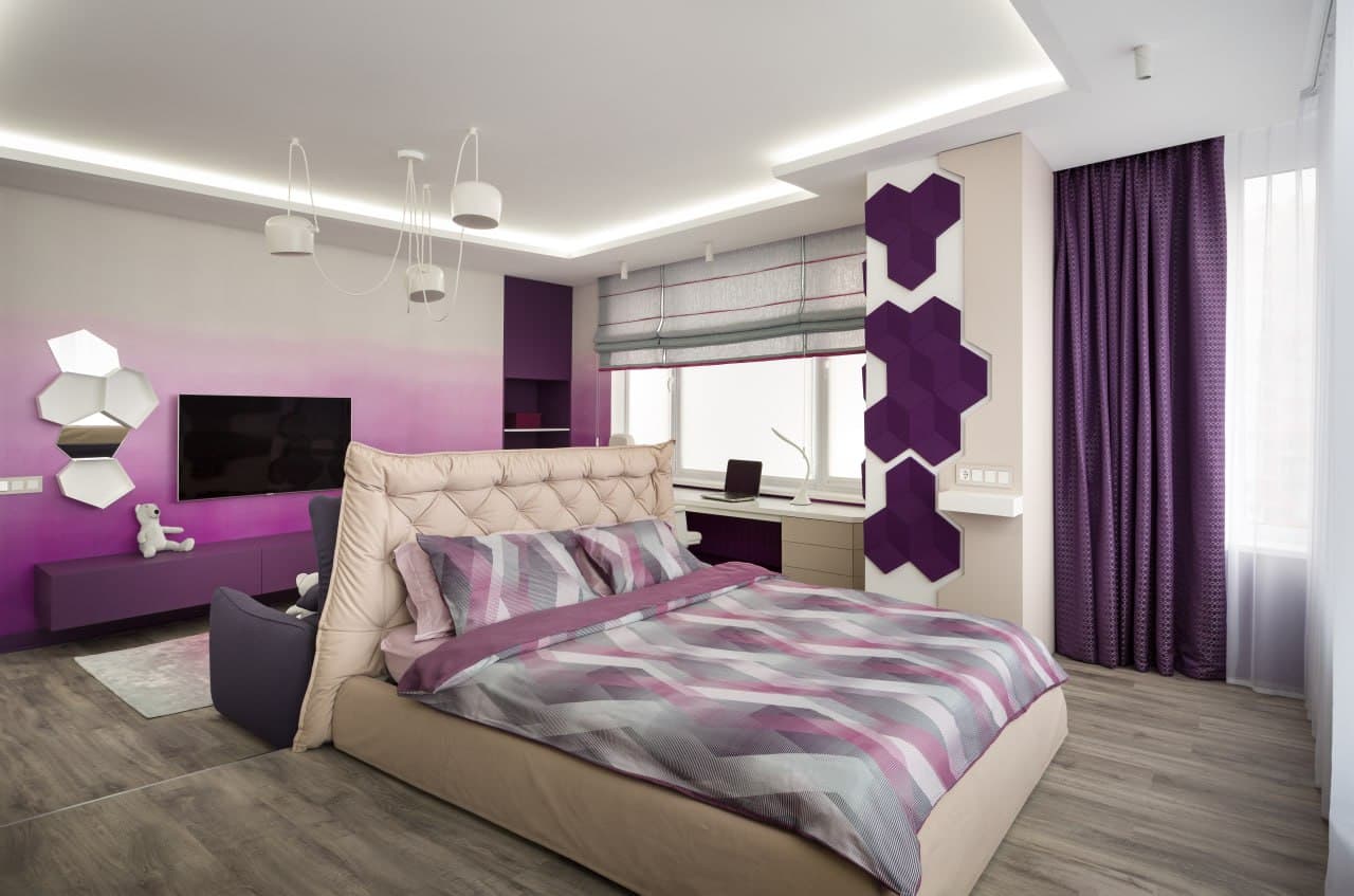 Bedroom and lounge zone with a geometric feature wall and decorative ceiling lighting