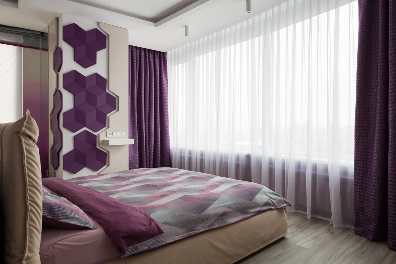 Bedroom with purple accent wall panels and a panoramic window