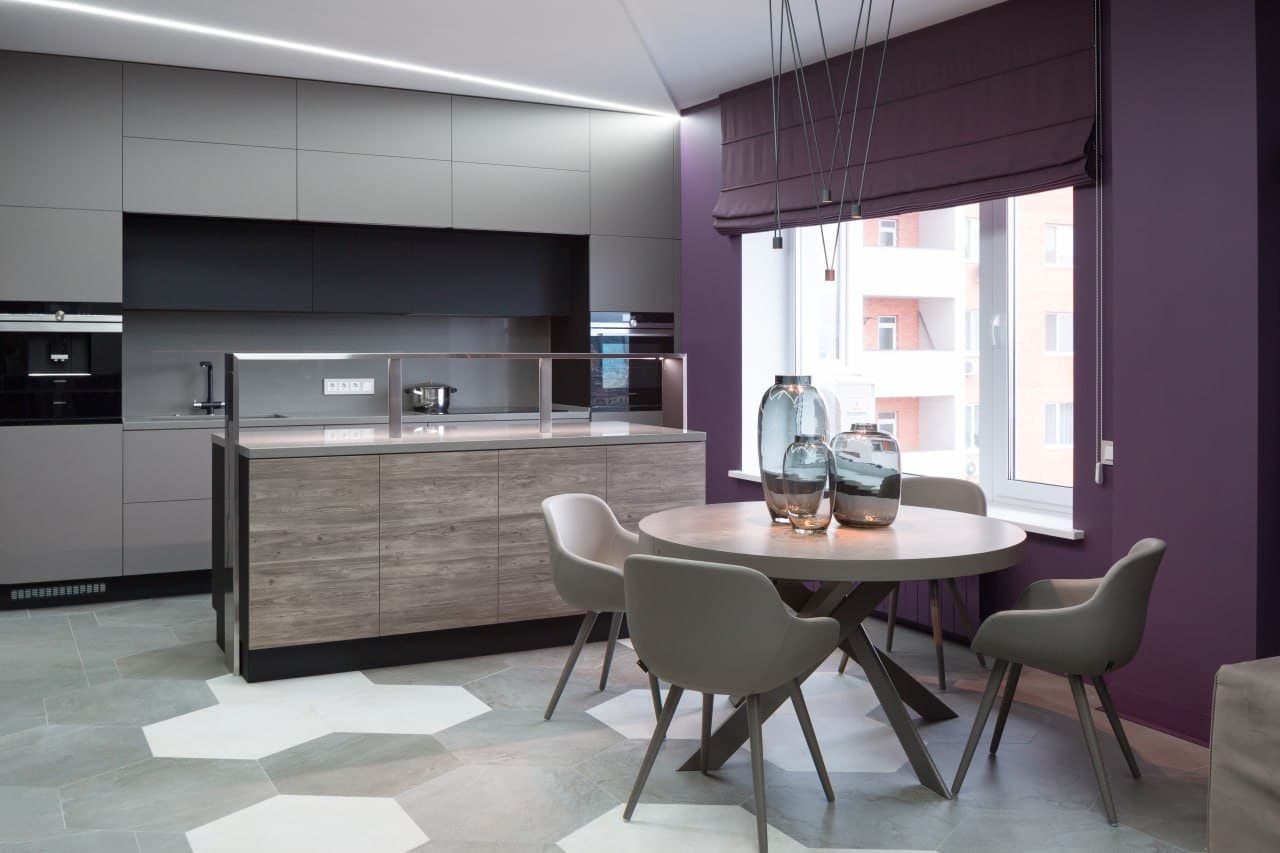Kitchen with minimalist cabinetry, decorative paint walls, and a violet window frame