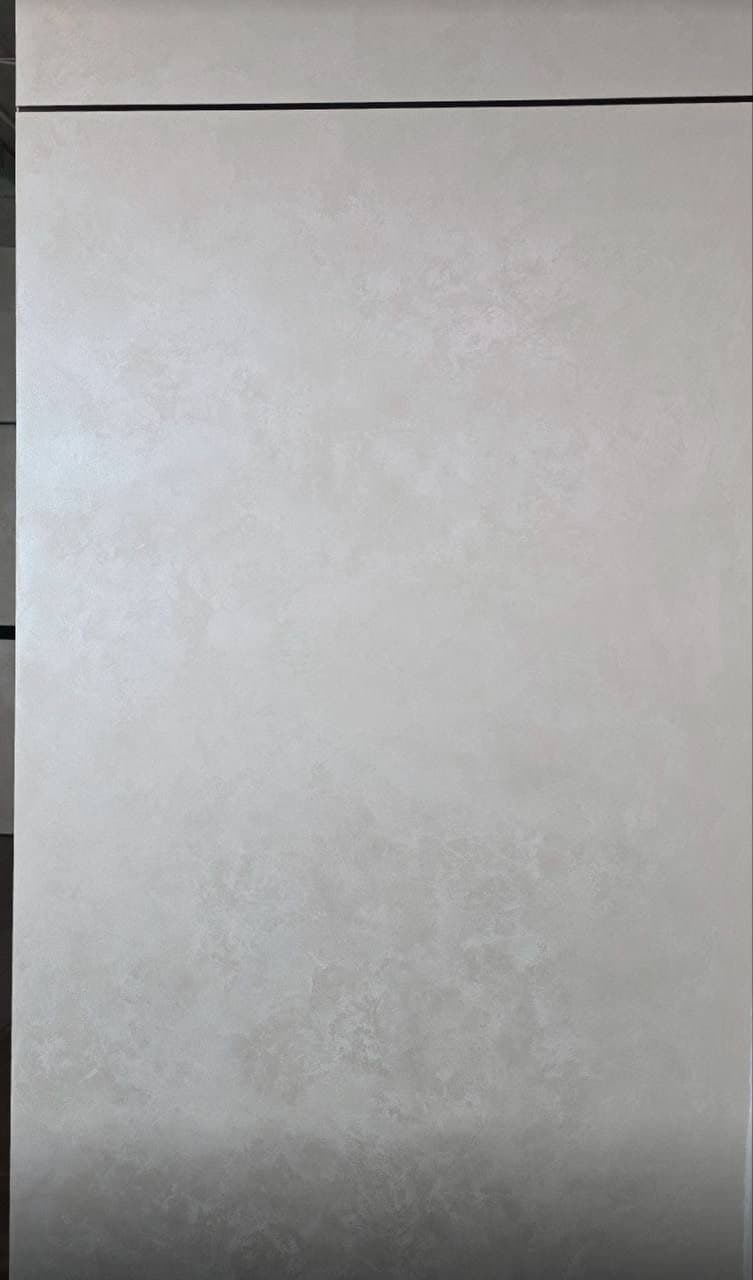 Decorative plaster wall close-up with a soft lime texture