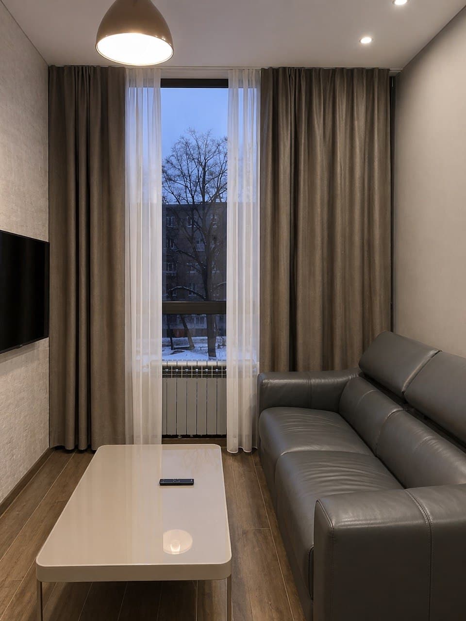 Lounge alcove with a daybed, full-height curtains, and a soft decorative finish